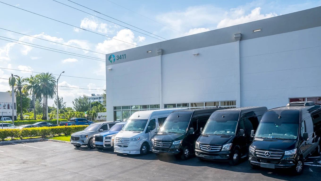 Aura Palm Sprinter vans and SUVs parked outside the company depot in South Florida