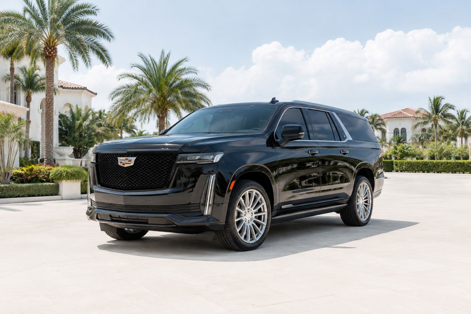 Black luxury SUV on a paved forecourt beside palms in South Florida