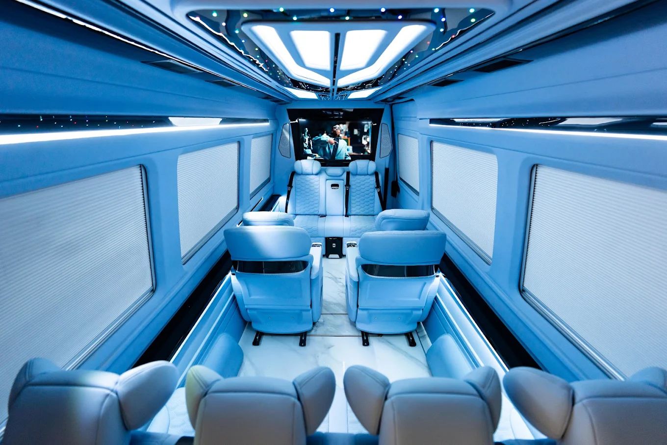 Lounge seating and ambient lighting inside an Aura Palm Sprinter cabin